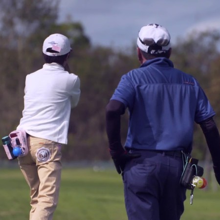 Two people playing park golf